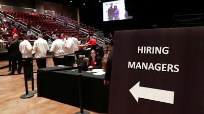 In this Tuesday, June 4, 2019, file photo, managers wait for job applicants at the Seminole Hard Rock Hotel & Casino Hollywood during a job fair in Hollywood, Fla. U.S. businesses added 183,000 jobs in Jan. 2020, a solid gain that shows the economy was largely healthy when the coronavirus outbreak spread further around the globe. Large companies added roughly two-thirds of the jobs, while hiring among smaller firms was relatively weak. Manufacturing and mining firms shed jobs, while hiring in health care and hotels and restaurants was strong.