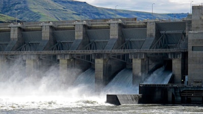 In this April 11, 2018 file photo, water moves through a spillway of the Lower Granite Dam on the Snake River near Almota, Wash. Farmers, environmentalists, tribal leaders and public utility officials are eagerly awaiting a federal report due Friday, Feb. 28, 2020, that could decide the fate of four hydroelectric dams on the Snake River.