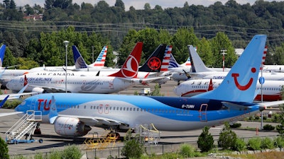 This Aug. 15, 2019, file photo shows dozens of grounded Boeing 737 Max airplanes crowd a parking area adjacent to Boeing Field in Seattle. A congressional committee says a “culture of concealment” at Boeing and poor oversight by federal regulators contributed to two deadly crashes involving the 737 Max jetliner. The House Transportation Committee issued a summary Friday, March 6, 2020, of its investigation so far into Boeing and the Federal Aviation Administration.