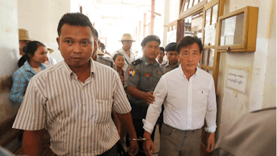 In the May 7, 2019, file photo, Myanmar national Shein Latt, left, and his boss U.S. national John Fredric Todoroki leave a local court after being arrested for operating a marijuana plantation in Ngazun Township, Mandalay region, central Myanmar. A Myanmar court on Tuesday sentenced Shein Latt to twenty years in prison under the country's drug laws concerning marijuana.