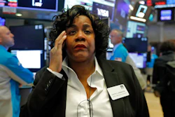 Yvette Arrington, with the New York Stock Exchange Trading Floor Operations, works on the floor of the NYSE, Monday, March 9, 2020. Stocks went into a steep slide Monday on Wall Street as coronavirus fears and a crash in oil prices spread alarm through the market, triggering the first automatic trading halt in over two decades.