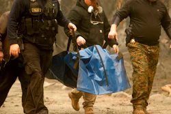 In this Wednesday, Nov. 14, 2018, file photo, sheriff's deputies recover the body of a Camp Fire victim in Paradise, Calif. Pacific Gas & Electric said Monday, March 23, 2020, it will plead guilty to 84 counts of involuntary manslaughter in connection with the 2018 fire in Northern California that killed 84 people and decimated three towns.