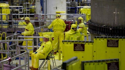 Workers gather near the Unit 2 reactor which is undergoing re-fueling during a tour of the Browns Ferry nuclear plant in Athens, Ala. U.S.