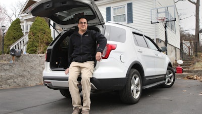 Tim Miranda, a software company manager currently working from home during the coronavirus outbreak, sits in his vehicle outside his Chelmsford, Mass. home, Thursday, April 2, 2020.