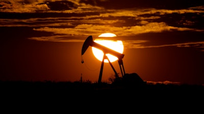 The sun sets behind an idle pump jack near Karnes City, Texas, Wednesday, April 8, 2020. Demand for oil continues to fall due to the new coronavirus outbreak.