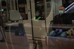 Commuters wearing face masks to protect against coronavirus at Atocha train station in Madrid, Spain, Monday, April 13, 2020.