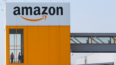 Employees observe social distancing due to coronavirus, at the entrance of Amazon, in Douai, northern France.