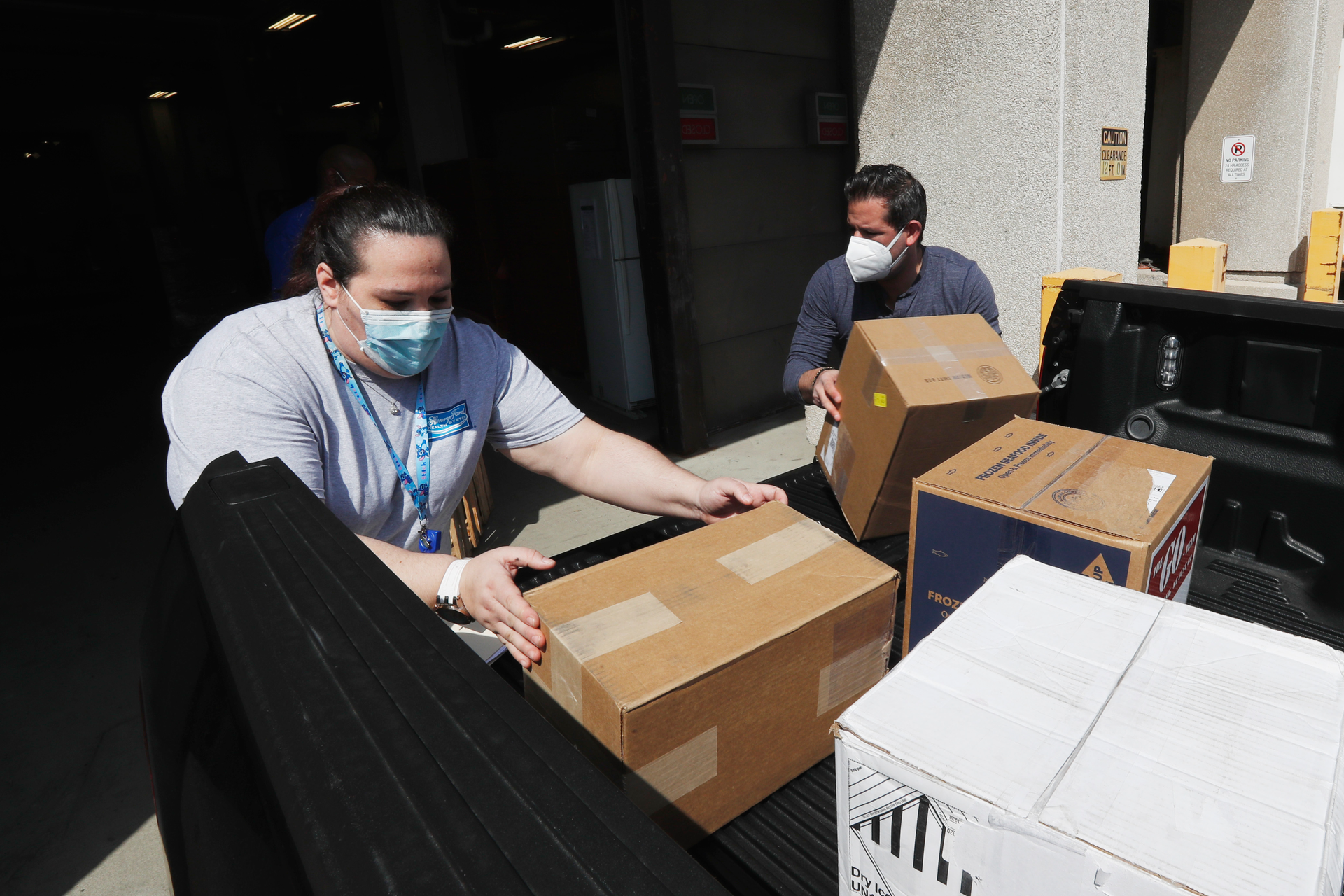 Christina Caldwell, left, of Henry Ford Population Health helps unload supplies with Matt Thatcher, who donated them from the Detroit Golf Club, Wednesday, April 8, 2020, in Detroit. The hospital is also in need of gowns and other PPE items and hopes more donations will be coming in from others to help during the coronavirus pandemic.
