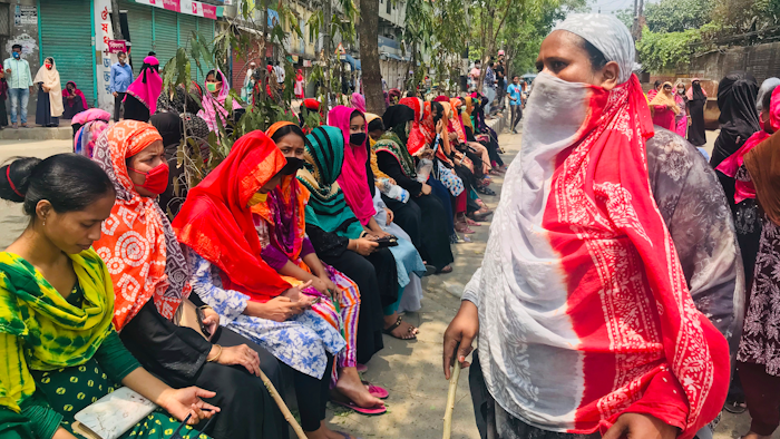 Bangladeshi garment workers block a road demanding their unpaid wages during a protest in Dhaka, Bangladesh, Thursday, April 16, 2020.