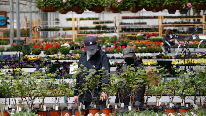 Shoppers look at plants at a nursery in Macomb, Mich., Monday, April 27, 2020.