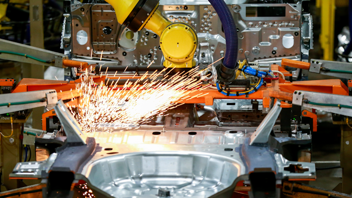 In this June 24, 2019, file photo machines work on a Ford vehicle assembly line at Ford's Chicago Assembly Plant in Chicago.
