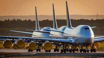 In this April 20, 2020 file photo, Lufthansa airline, Boeing 747 aircrafts are parked at the airport in Frankfurt, Germany. Boeing says it will cut about 10% of its work force and slow production of planes as it deals with the ongoing grounding of its best-selling plane and the coronavirus pandemic. With air travel falling sharply because of the virus, airlines have delayed orders and deliveries of new planes, reducing Boeing’s revenue.