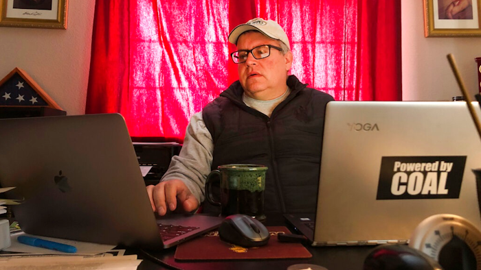 In this Monday April 13, 2020 photo Wyoming Mining Association Executive Director Travis Deti, seen here working from his home in Cheyenne, Wyo. Deti has been calling for help for the coal industry in the form of lower federal royalties and other aid. Analysts expect less electricity use during the coronavirus pandemic to lower demand for coal even below a previously predicted decline.