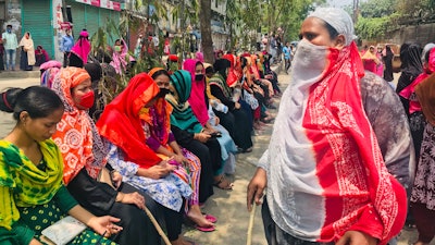 Bangladeshi garment workers block a road demanding their unpaid wages during a protest in Dhaka, Bangladesh, Thursday, April 16, 2020.