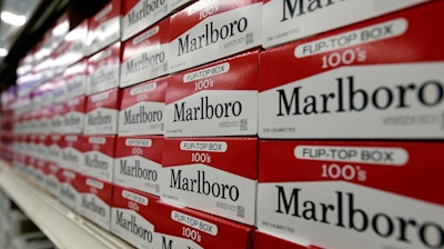 This June 14, 2018, file photo shows cartons of Marlboro cigarettes on the shelves at JR outlet in Burlington, N.C.