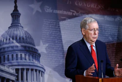 Senate Majority Leader Mitch McConnell speaks with reporters after the Senate approved a nearly $500 billion coronavirus aid bill Tuesday on Capitol Hill in Washington.