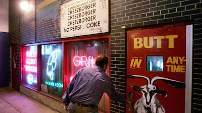 A customer enters the Billy Goat Tavern under Chicago's Michigan Ave.