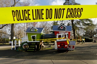 Police tape is used to keep people from using a playground.