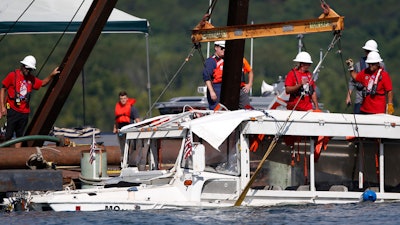 In this July 23, 2018, file photo, a duck boat that sank in Table Rock Lake in Branson, Mo., is raised after it went down the evening of July 19.
