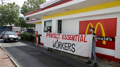 People protest what they say is a lack of personal protective equipment for employees.