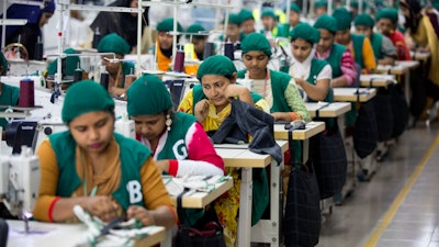 In this April 19, 2018 file photo, trainees work at Snowtex garment factory in Dhamrai, near Dhaka, Bangladesh.