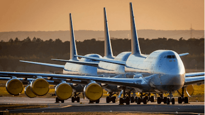 In this April 20, 2020 file photo, Lufthansa airline, Boeing 747 aircrafts are parked at the airport in Frankfurt, Germany. Boeing says it will cut about 10% of its work force and slow production of planes as it deals with the ongoing grounding of its best-selling plane and the coronavirus pandemic. With air travel falling sharply because of the virus, airlines have delayed orders and deliveries of new planes, reducing Boeing’s revenue.