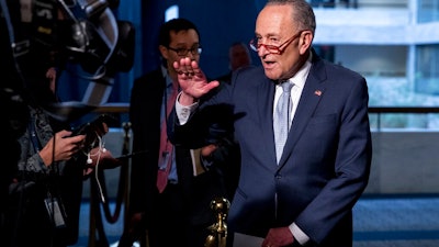 In this March 20, 2020, file photo Senate Minority Leader Sen. Chuck Schumer of N.Y., speaks to reporters as he arrives for a meeting to discuss the coronavirus relief bill on Capitol Hill Washington. The Trump administration and Congress are nearing an agreement as early as Sunday, April 19, on a $400-plus billion aid package to boost a small-business loan program that has run out of money and add funds for hospitals and COVID-19 testing.