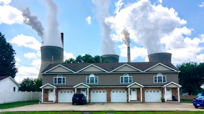 In this Aug. 23, 2018, file photo, a coal-fired plant in Winfield, W.Va, is seen from an apartment complex in the town of Poca across the Kanawha River. The Trump administration is gutting an Obama-era rule that compelled coal plants to cut back emissions of mercury and other human health hazards, limiting future regulation of air pollutants by petroleum and coal plants.