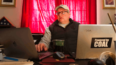 In this Monday April 13, 2020 photo Wyoming Mining Association Executive Director Travis Deti, seen here working from his home in Cheyenne, Wyo. Deti has been calling for help for the coal industry in the form of lower federal royalties and other aid. Analysts expect less electricity use during the coronavirus pandemic to lower demand for coal even below a previously predicted decline.