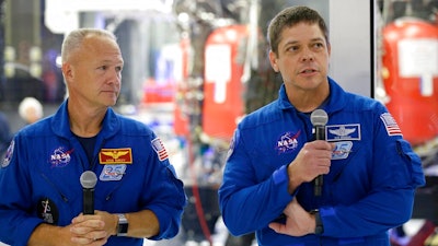 In this Thursday, Oct. 10, 2019 file photo, NASA astronauts Bob Behnken, right, and Doug Hurley talk to the media in front of the Crew Dragon spacecraft at SpaceX headquarters in Hawthorne, Calif. On Friday, April 17, 2020, NASA and SpaceX announced May 27 for resuming human launches from the U.S. after nearly a decade. Hurley and Behnken will blast off atop a SpaceX Falcon 9 rocket, departing from the same Kennedy Space Center launch pad used by Atlantis in July 2011.