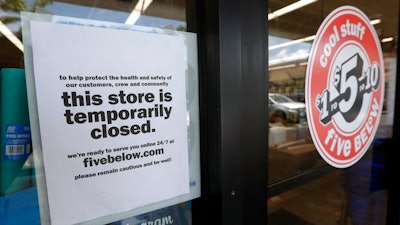 In this April 23, 2020 file photo, a sign is posted on a closed store in North Miami, Fla. Banks trying to submit applications for thousands of small businesses seeking coronavirus relief loans have hit a bottleneck for a second day at the Small Business Administration. Banking industry groups say the SBA’s loan processing system is still unable to handle the volume of loan applications from business owners trying to get aid under the Paychceck Protection Program, part of the government’s $2 trillion coronavirus aid program.