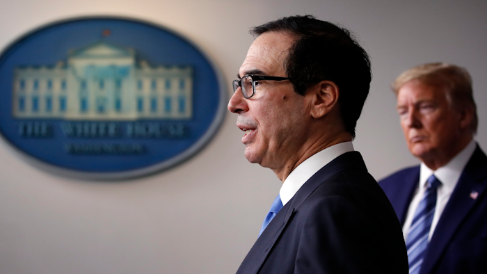 President Donald Trump listens as Treasury Secretary Steven Mnuchin speaks about the coronavirus.