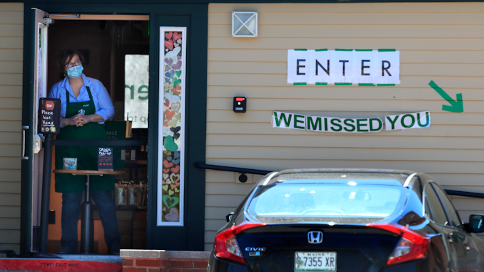 Becky Richards keeps an eye out for customers at a recently-reopened Starbucks.