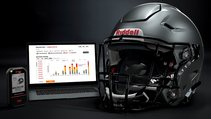 A Riddell SpeedFlex helmet sits next to a computer screen displaying information from the InSite tool.