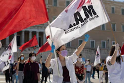 Protesters from the communist party-affiliated PAME union march during a May Day rally outside the Greek Parliament.