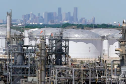 In this April 30 photo, storage tanks at a refinery along the Houston Ship Channel are seen with downtown Houston in the background.