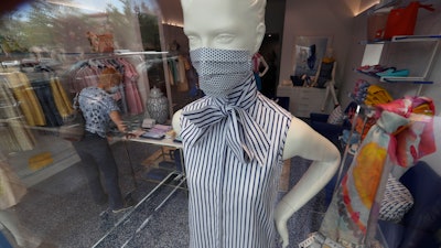 A mannequin displays fashion masks for shoppers the buy at the Highland Park Village shopping center in Dallas.