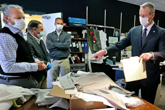 Gov. Charlie Baker, right, wearing a protective mask for the coronavirus pandemic.