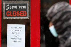 A pedestrian walks by The Framing Gallery, closed due to the COVID-19 pandemic, in Grosse Pointe, MI on Thursday, May 7.
