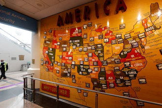 A lone security officer walks past a map of America in the main terminal of Denver International Airport.