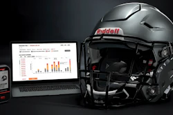 A Riddell SpeedFlex helmet sits next to a computer screen displaying information from the InSite tool.