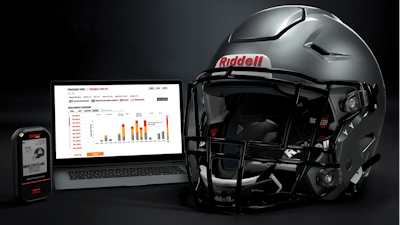 A Riddell SpeedFlex helmet sits next to a computer screen displaying information from the InSite tool.