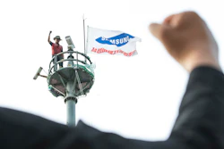A former Samsung employee Kim Yong-hee is seen atop an 82-foot traffic camera tower in Seoul, South Korea.