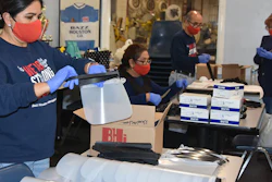 Workers and volunteers at Bazz Houston International assemble face shields.