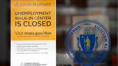 A sign announces the closure of the Massachusetts Unemployment Office, Saturday, May 9, 2020, in Boston.
