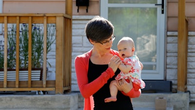 Sara Adelman holds her daughter Amelia in Salt Lake City.