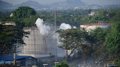 Smoke rises from LG Polymers plant.
