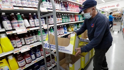 Juan Santos stocks shelves at the Presidente Supermarket in the Little Havana neighborhood of Miami.