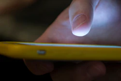 A man uses a cell phone.