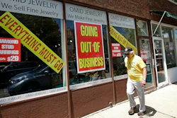 A man walks past a retail store that is going out of business due to the coronavirus pandemic in Winnetka, Ill., June 23, 2020.